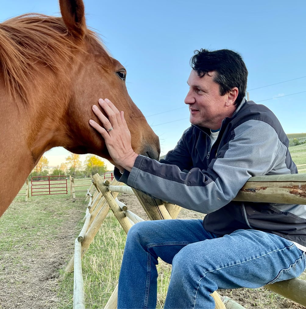 Oniya guest bonding with a horse during their Equine Assisted Learning session