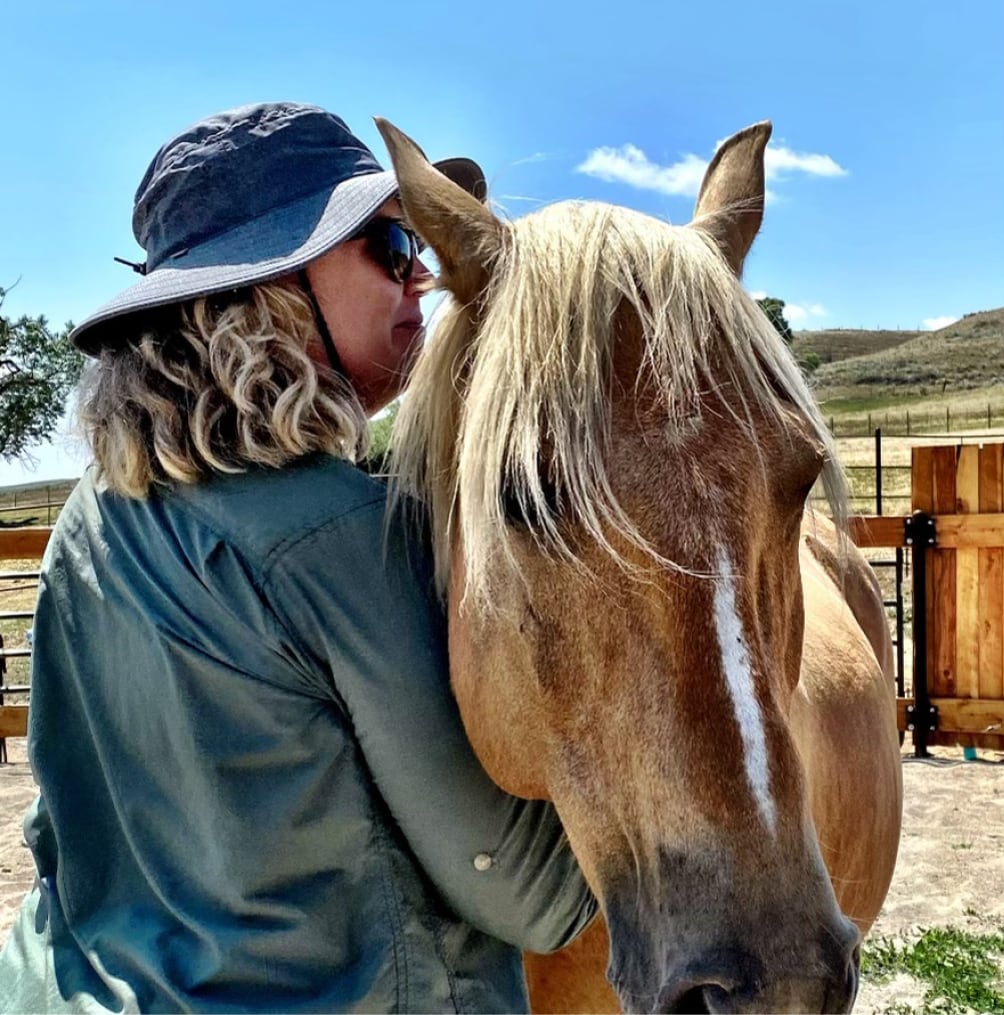 Oniya guest bonding with a horse during their Equine Assisted Learning session