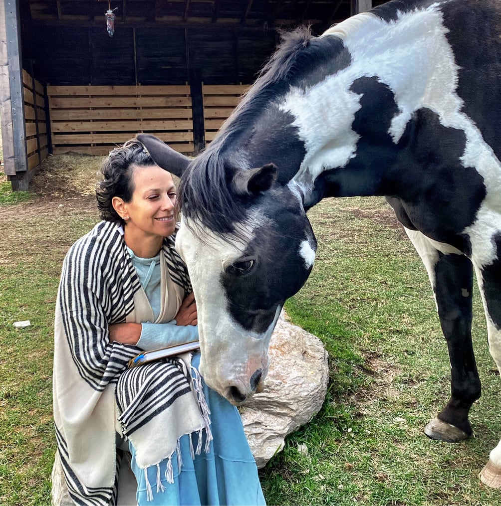 Oniya guest bonding with a horse during their Equine Assisted Learning session